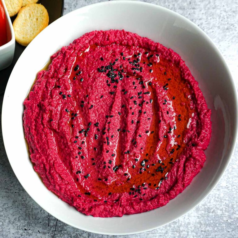 beetroot hummus garnished with black sesame seeds