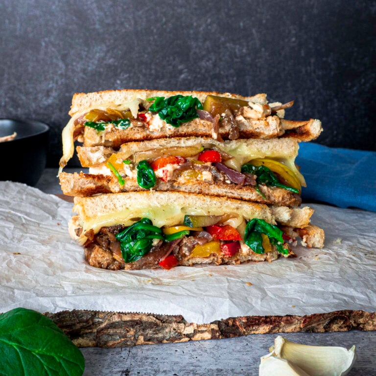 stacked vegetable sandwich in balsamic glaze with pepper jack cheese on sourdough bread