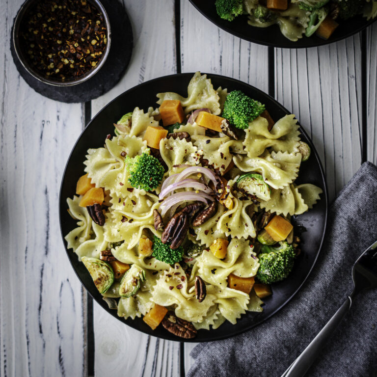 farfalle pasta with sweet potatoes, onions, brussels sprouts, pecans, and broccoli