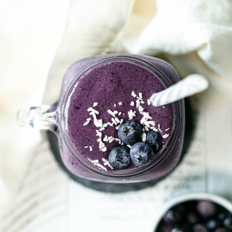 protein smoothie with blueberries and coconut flakes