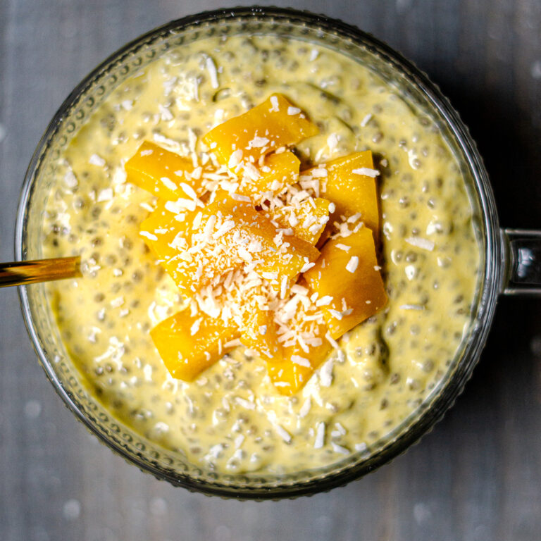 mango chia pudding topped with mango chunks and coconut flakes
