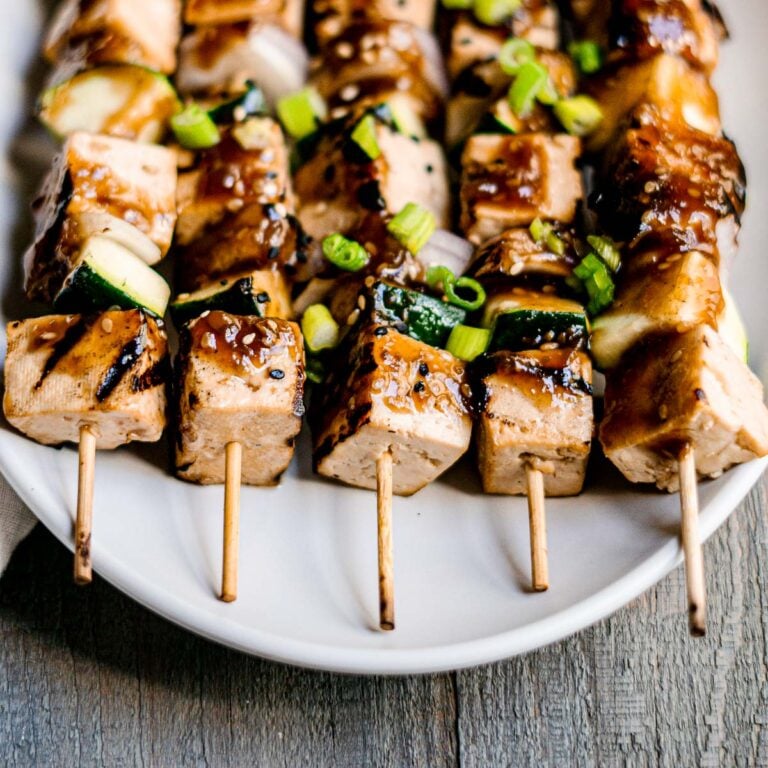 tofu skewers with teriyaki sauce, topped with scallions and sesame seeds