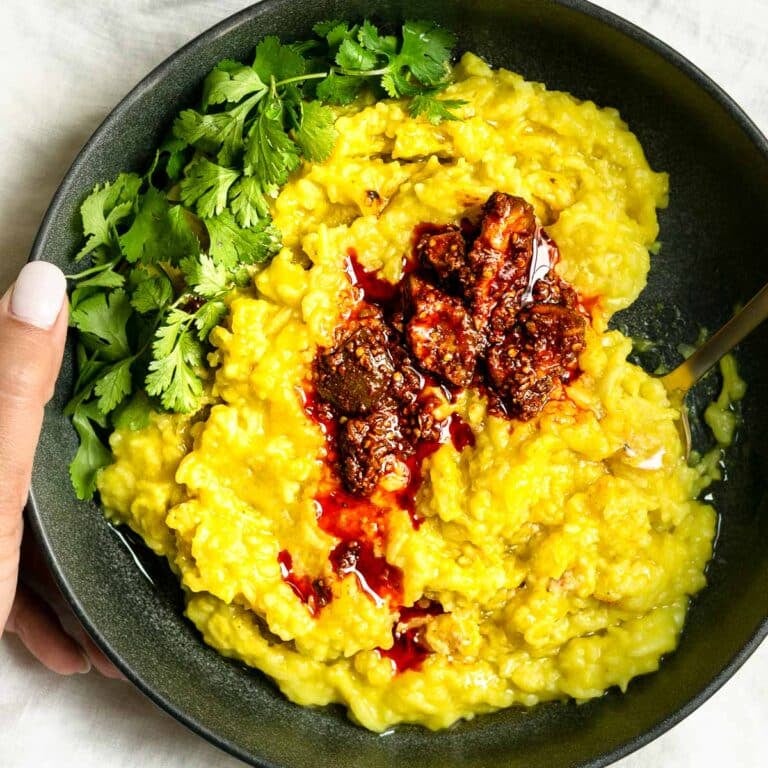 khichdi served with cilantro and spicy pickled mango