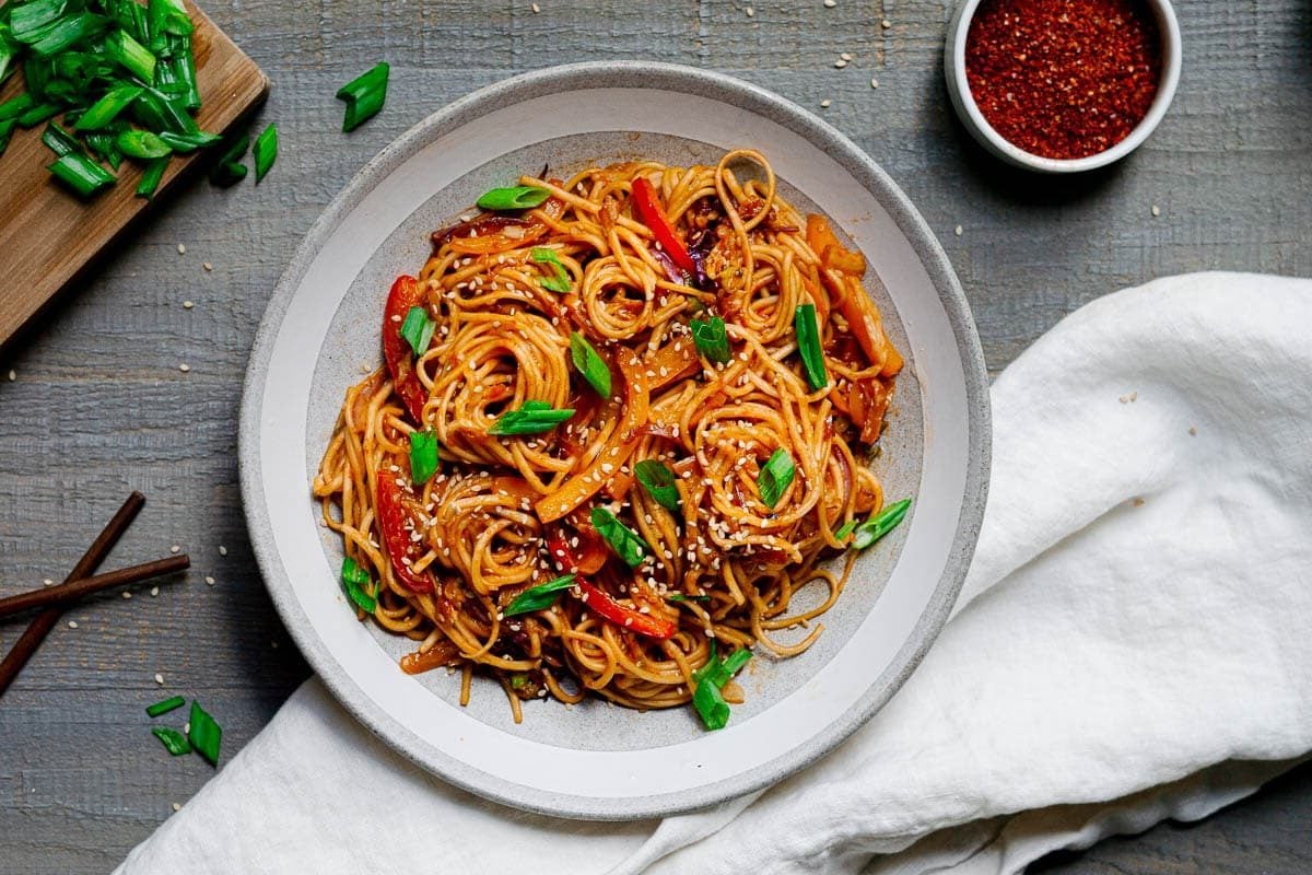 plated spicy gochujang noodles garnished with scallions